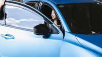woman sitting in blue car woman sitting in blue car