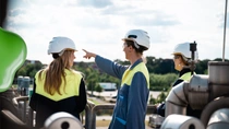 Group of people pointing in the distance on factory roof. Group of people pointing in the distance on factory roof.