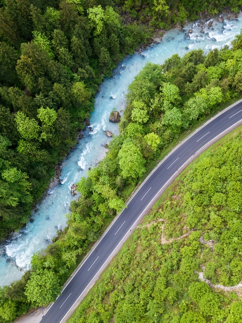 The whitewater river Steyr next to a paved road. The water is still blue from the melting snow in the montains in springtime. Location: next to the small ski resort Hinterstoder in the "Totes Gebirge" area in Upper Austria.