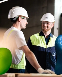 Two workers smiling at each other. Two workers smiling at each other.