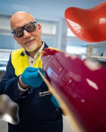 Scientist holding red color panel. Scientist holding red color panel.