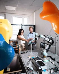 Two people working with robots. Two people working with robots.