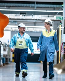 Two workers walking in factory. Two workers walking in factory.